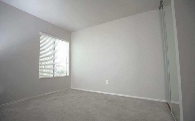 Empty rental property room with carpet cleaned for the end of lease inspection
