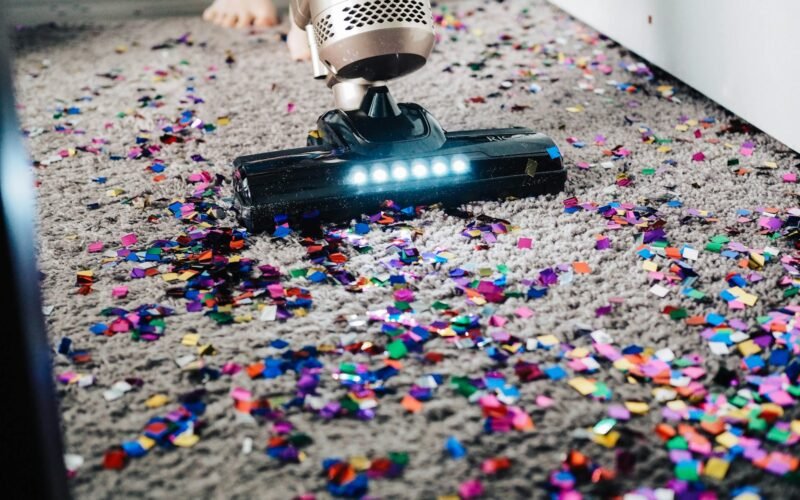 Carpet cleaning technician deep cleaning a carpet with professional hot water extraction equipment