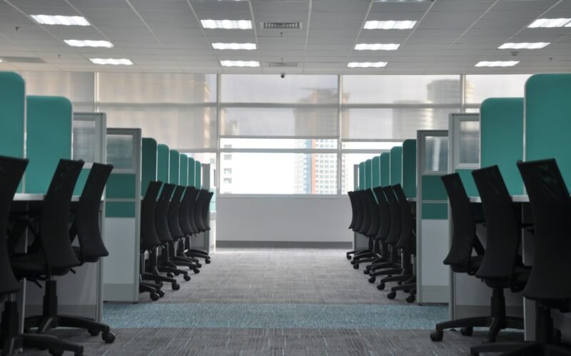 Open plan office with rows of workstations on freshly cleaned commercial carpet