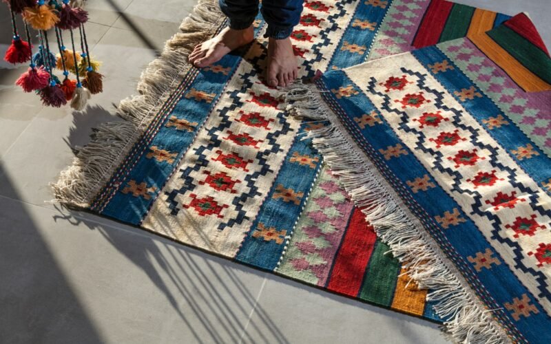 Person standing on a clean patterned area rug in a home