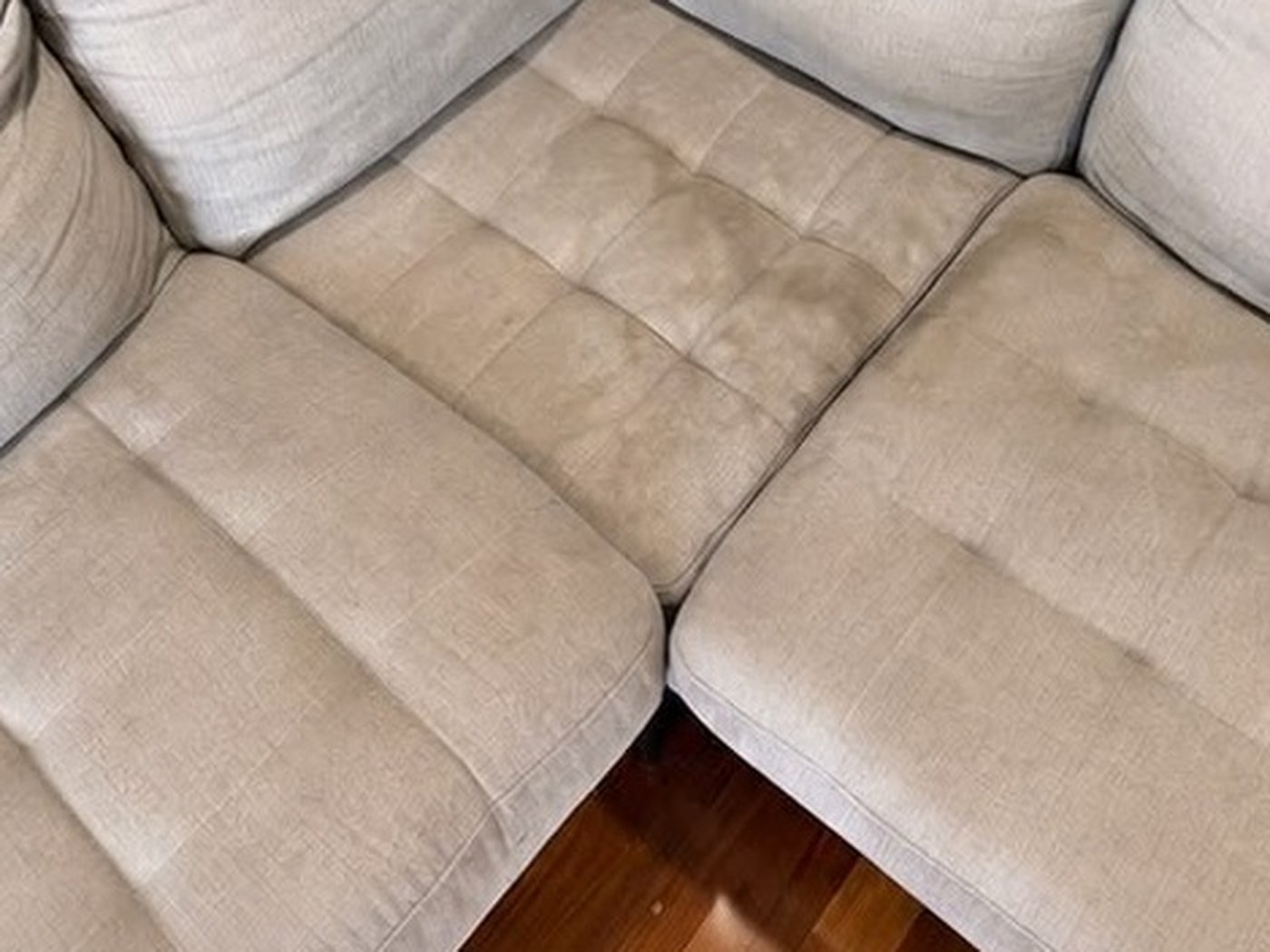 Fabric corner lounge, seat and back cushions. Before cleaning.