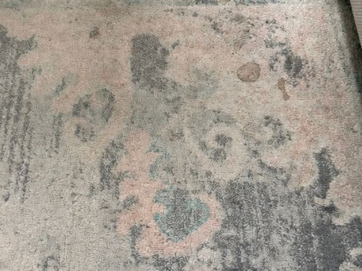 Patterned rug, spotting and general soiling. Before cleaning.
